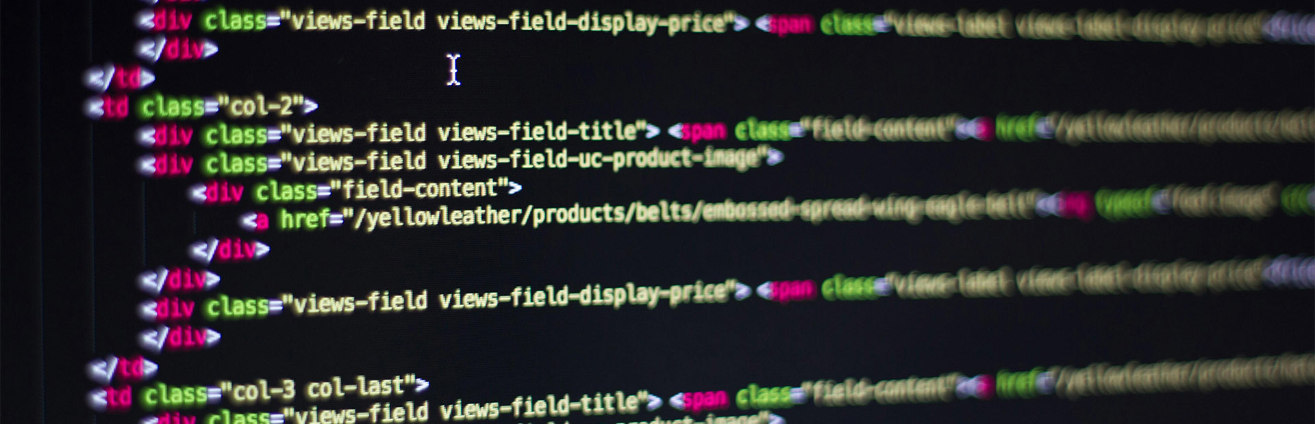 A close up of a computer screen showing website development code